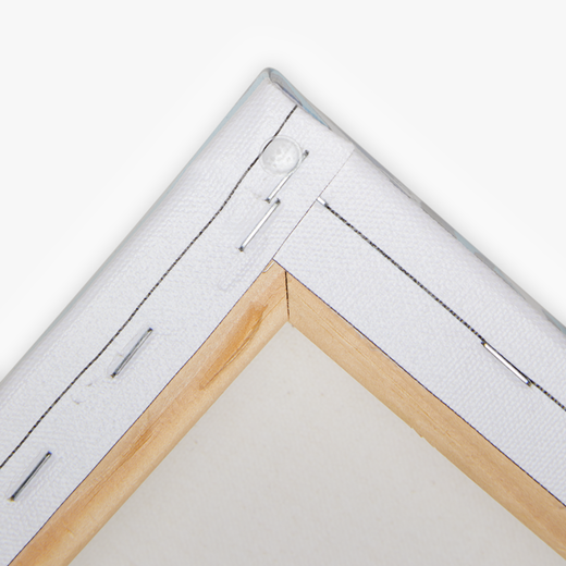 Close-up of stapled and folded canvas corner over pine frame